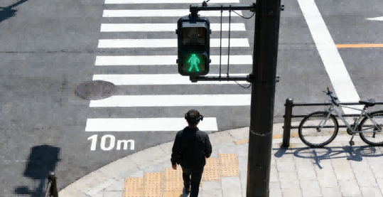 A man with Timsee smart glasses navigates a crosswalk, attentive to traffic and pedestrians.
